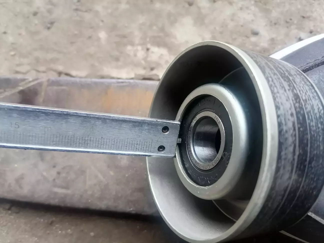Так як новий підшиник розміром 17х40х12, а старий 17х40х14, то для того щоб як було і ролик на натягувачі не змінив свого положення по горизонталі, заміряємо глибину розташування старого підшипника від внутрішньої грані ролика - 2,4 мм