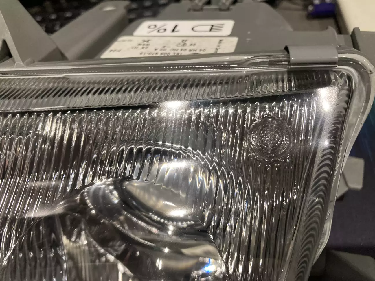 В правом верхнем углу, кружок, в котором на оригинальной фаре будет логотип Alfa Romeo.